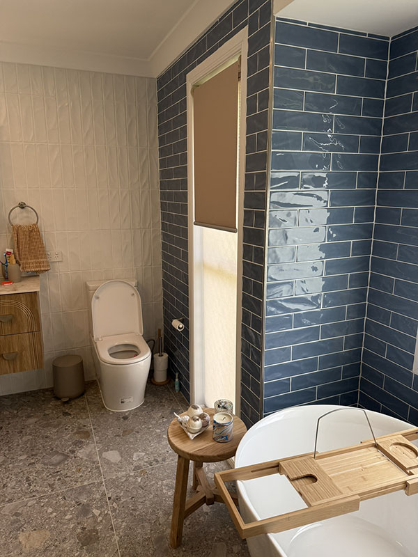Blue subway tiled bathroom area