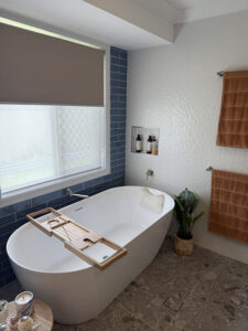 Freestanding bath with tiled walls and window