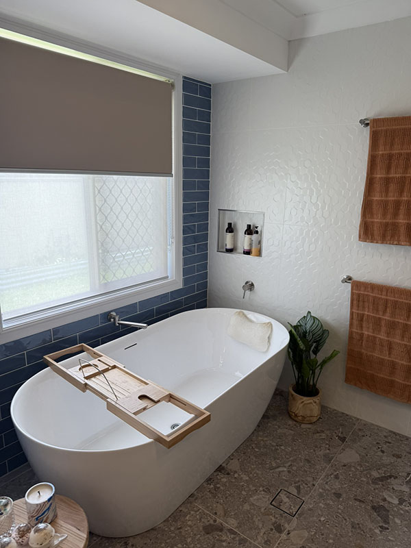 Freestanding bath with tiled walls and window