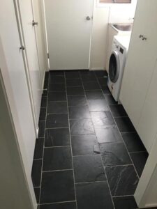 Laundry floor tiled with natural black slate tiles