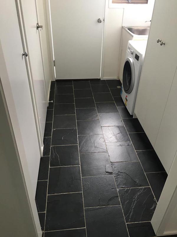 Laundry floor tiled with natural black slate tiles