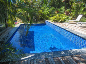 Tiled swimming pool, surrounded by timber deck